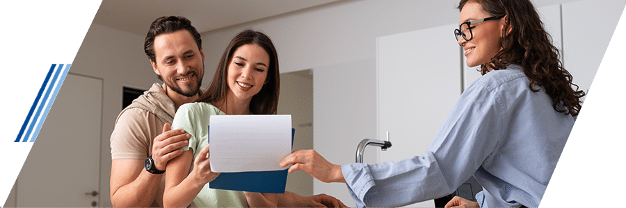 Pareja recibiendo asesoría sobre crédito hipotecario con agente inmobiliario