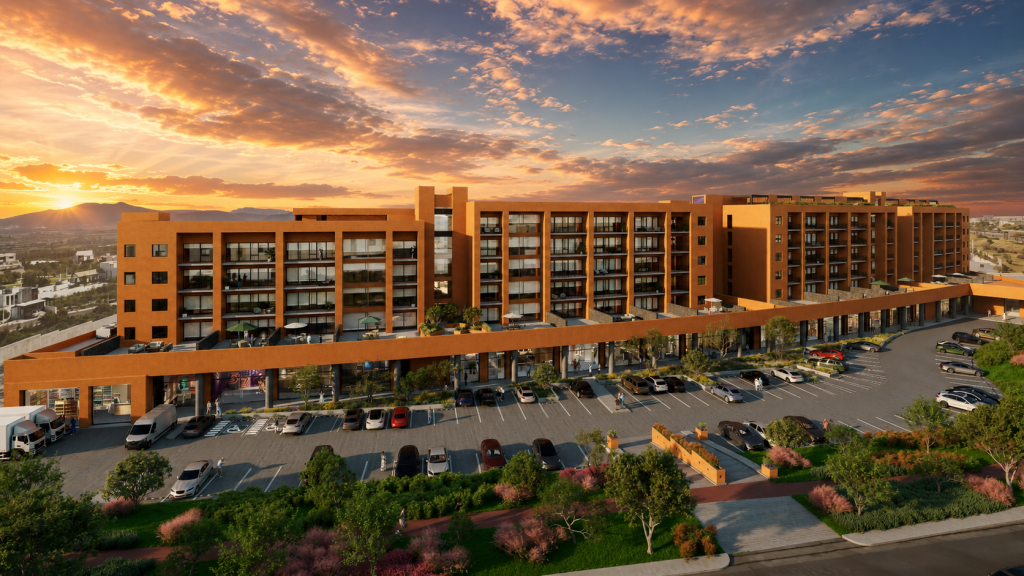 Aerial view of a terracotta-colored multi-story residential complex with a curved ground-floor row of shops and a parking lot, at sunset.